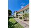 Exterior view of a condo building with well-maintained landscaping and walkway at 3504 Beneva Rd # 206, Sarasota, FL 34239