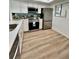 Updated kitchen featuring white cabinets, stainless steel appliances, and quartz countertops at 3504 Beneva Rd # 206, Sarasota, FL 34239