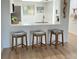 Kitchen breakfast bar with three wood and fabric stools at 3504 Beneva Rd # 206, Sarasota, FL 34239