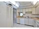 Kitchen features light cabinets, dishwasher and a view to living room at 3620 Ironwood Cir # 206O, Bradenton, FL 34209