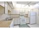 Efficient kitchen with white cabinets and modern appliances at 3620 Ironwood Cir # 206O, Bradenton, FL 34209