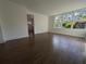 Living room with wood flooring and access to kitchen at 3829 Nottingham Dr, Sarasota, FL 34235