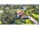 Luxury home with tile roof and lush landscaping situated on a golf course at 401 Walls Way, Osprey, FL 34229
