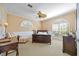 Comfortable bedroom with carpet, arched windows, and built-in shelving at 401 Walls Way, Osprey, FL 34229