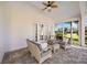 Relaxing covered patio with wicker furniture, overlooking a lush green landscape at 401 Walls Way, Osprey, FL 34229
