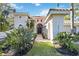 Front entry of two-story house with tile roof and walkway at 401 Walls Way, Osprey, FL 34229