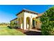 Inviting home exterior featuring arched entryway and landscaping at 406 Wildlife Gln, Bradenton, FL 34209