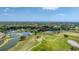 Aerial view of community with golf course and water features at 4211 Palacio Dr, Sarasota, FL 34238
