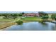 Aerial view of clubhouse near golf course and pond at 4211 Palacio Dr, Sarasota, FL 34238