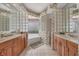 Bathroom boasts double vanity, soaking tub, and glass block accents at 4211 Palacio Dr, Sarasota, FL 34238
