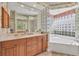Large bathroom with double sinks and a relaxing soaking tub at 4211 Palacio Dr, Sarasota, FL 34238