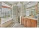 Spa-like bathroom with a corner soaking tub and double vanity at 4211 Palacio Dr, Sarasota, FL 34238