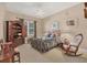 Charming bedroom with a floral bedspread and rocking chair at 4211 Palacio Dr, Sarasota, FL 34238