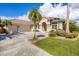 Single-Gathering house with a three-car garage and landscaped yard at 4211 Palacio Dr, Sarasota, FL 34238