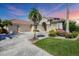 Attractive single-Gathering home with three-car garage, manicured lawn, and palm trees at 4211 Palacio Dr, Sarasota, FL 34238