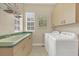 Bright laundry room with washer, dryer, and ample cabinets at 4211 Palacio Dr, Sarasota, FL 34238