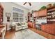 Bright home office, featuring built-in shelves and a comfortable sitting area at 4211 Palacio Dr, Sarasota, FL 34238