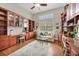Home office with built-in bookshelves and desks at 4211 Palacio Dr, Sarasota, FL 34238