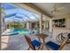 Relaxing poolside patio with table and chairs, screened enclosure at 4211 Palacio Dr, Sarasota, FL 34238