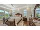 Bedroom with hardwood floors, private balcony, and views of the marina at 510 Bowsprit Ln, Longboat Key, FL 34228