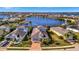 Stunning aerial view of waterfront homes with private pools, docks, and lush landscaping in a desirable neighborhood at 5403 Tidewater Preserve Blvd, Bradenton, FL 34208