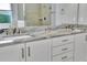 Double vanity bathroom with a sleek granite countertop and modern hardware at 5403 Tidewater Preserve Blvd, Bradenton, FL 34208