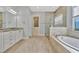 Spacious bathroom with double vanity, soaking tub, and walk-in shower at 5403 Tidewater Preserve Blvd, Bradenton, FL 34208
