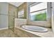 Bathroom features a large soaking tub, walk-in shower, and window at 5403 Tidewater Preserve Blvd, Bradenton, FL 34208