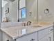 Modern bathroom vanity with a white sink and speckled countertop at 5403 Tidewater Preserve Blvd, Bradenton, FL 34208