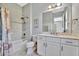 Bathroom with white vanity, bathtub, and tile shower at 5403 Tidewater Preserve Blvd, Bradenton, FL 34208