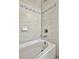 Clean white bathtub with light gray tile surround at 5403 Tidewater Preserve Blvd, Bradenton, FL 34208