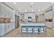 Open concept kitchen with white cabinets, island and stainless steel appliances at 5403 Tidewater Preserve Blvd, Bradenton, FL 34208
