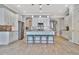 Open concept kitchen with white cabinets and a large island at 5403 Tidewater Preserve Blvd, Bradenton, FL 34208