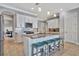 Modern kitchen with white cabinets, granite island, and teal bar stools at 5403 Tidewater Preserve Blvd, Bradenton, FL 34208
