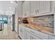 White kitchen cabinets, granite countertops, and tile backsplash at 5403 Tidewater Preserve Blvd, Bradenton, FL 34208