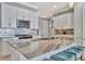 Modern kitchen with white cabinets, granite island, and teal bar stools at 5403 Tidewater Preserve Blvd, Bradenton, FL 34208