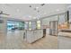 Open kitchen with island, stainless steel appliances, and views of the pool and canal at 5403 Tidewater Preserve Blvd, Bradenton, FL 34208