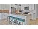 Modern kitchen with white cabinets, granite island, and teal bar stools at 5403 Tidewater Preserve Blvd, Bradenton, FL 34208