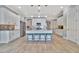 Open concept kitchen with white cabinets and large kitchen island at 5403 Tidewater Preserve Blvd, Bradenton, FL 34208
