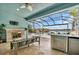 Relaxing lanai with fireplace and seating area overlooking the pool and water at 5403 Tidewater Preserve Blvd, Bradenton, FL 34208