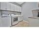 Laundry room with white cabinets, LG washer and dryer at 5403 Tidewater Preserve Blvd, Bradenton, FL 34208