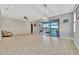 Open living room, tile floors, and sliding glass doors leading to patio at 5403 Tidewater Preserve Blvd, Bradenton, FL 34208