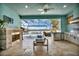 Outdoor kitchen with fireplace,water views, and stainless steel appliances at 5403 Tidewater Preserve Blvd, Bradenton, FL 34208