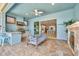 Covered outdoor kitchen with stainless steel appliances and seating area at 5403 Tidewater Preserve Blvd, Bradenton, FL 34208