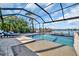 Screened pool and spa overlooking a canal with boats at 5403 Tidewater Preserve Blvd, Bradenton, FL 34208