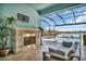 Relaxing poolside patio with fireplace and water view at 5403 Tidewater Preserve Blvd, Bradenton, FL 34208