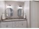 Double vanity bathroom with granite countertops and white cabinets at 5727 Magnolia Ridge Pl, Sarasota, FL 34243