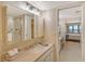 Updated bathroom with vanity, shower, and access to bedroom at 5911 Midnight Pass Rd # 504, Sarasota, FL 34242