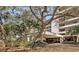 Building entrance with lush landscaping and covered entryway at 5911 Midnight Pass Rd # 504, Sarasota, FL 34242
