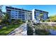 Condo building with water access, lush landscaping, and private boat slips at 5911 Midnight Pass Rd # 504, Sarasota, FL 34242